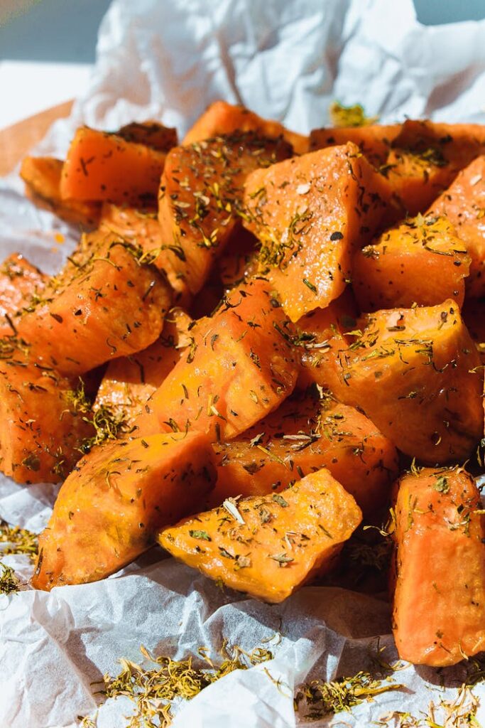 pexels photo 3233282 Close-up of delicious baked sweet potatoes seasoned with herbs, perfect for a healthy meal.